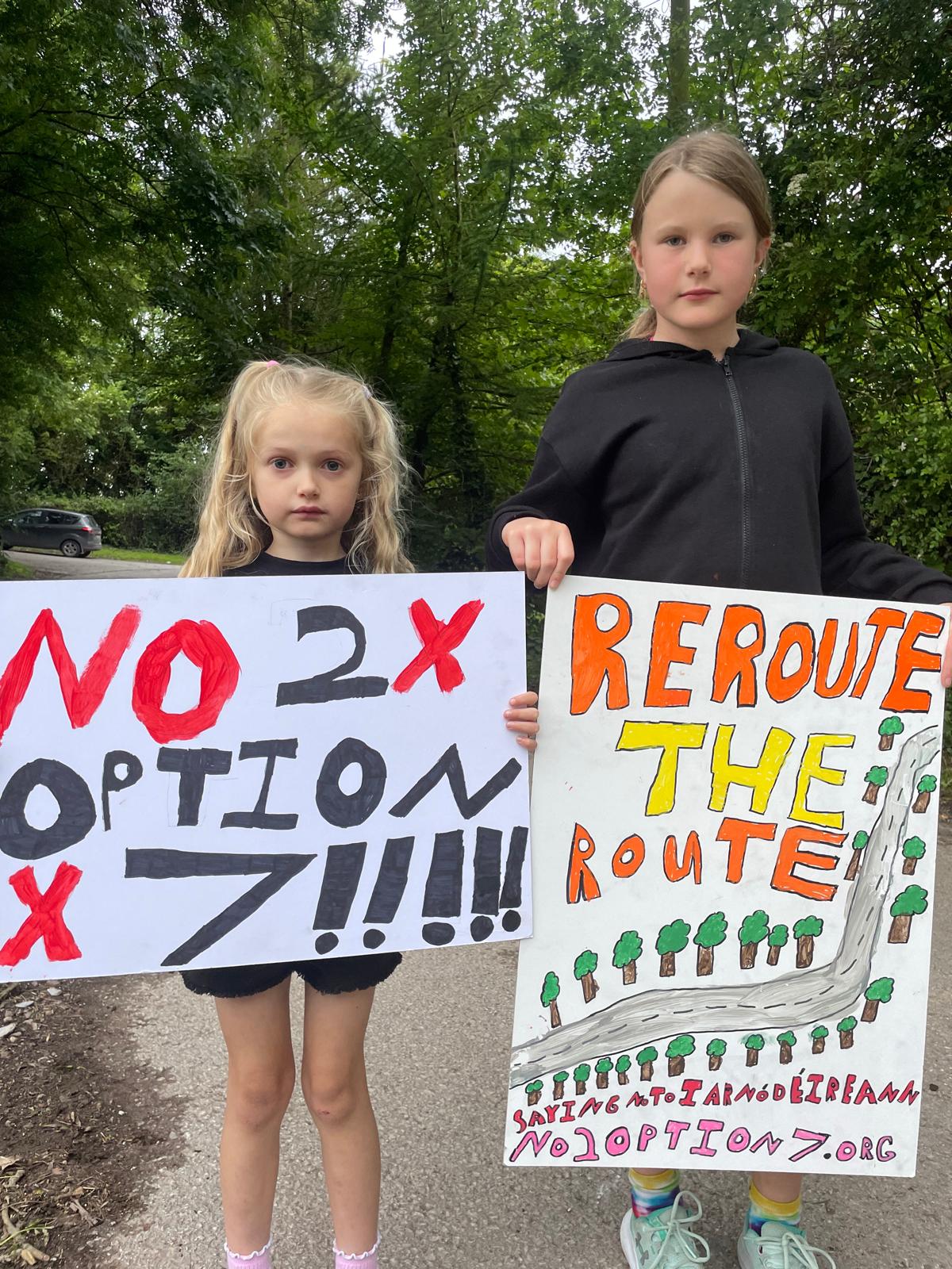 Two young girls with handmade signs